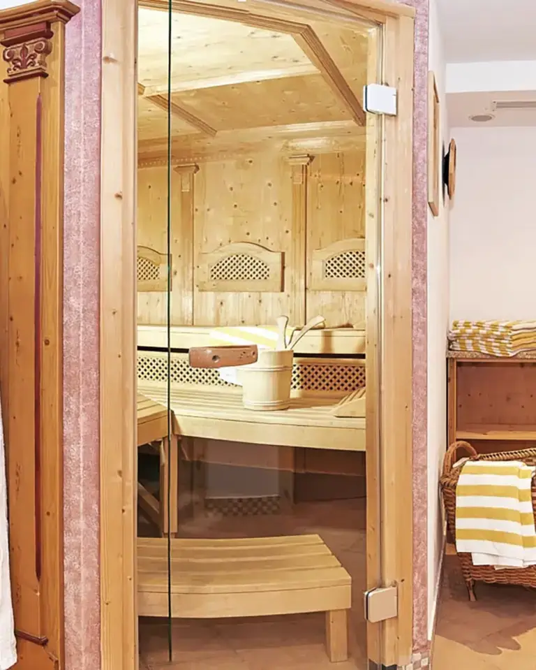 Blick durch die Glastür in die Sauna im Wellnessbereich des Hundsreitlehen