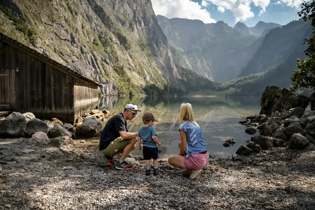 Familie am Ufer des Obersees mit Blick zur Fischunkelalm